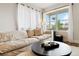 Cozy living room with large window and comfortable, neutral-toned furniture at 12740 Tamarac St, Thornton, CO 80602