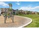 Scenic community playground featuring swings and vibrant neighborhood homes in the background at 12740 Tamarac St, Thornton, CO 80602