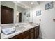 Bathroom featuring double sinks, a large mirror, and decorative art creating a unique and inviting space at 2290 S Braun Way, Lakewood, CO 80228