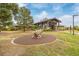 Visitor center with nature-themed sculpture, surrounded by lush landscaping and trees in a community park at 2290 S Braun Way, Lakewood, CO 80228