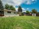 Well-maintained lawn in a fenced backyard with mature trees and convenient shed at 7936 Eaton St, Arvada, CO 80003