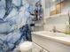 Bathroom featuring unique wallpaper and shower curtain and modern fixtures at 7936 Eaton St, Arvada, CO 80003