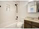 Cozy bathroom featuring a shower over tub and a dark-wood vanity sink at 7936 Eaton St, Arvada, CO 80003