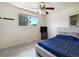 Bright bedroom with a large window, ceiling fan, and hardwood floors at 7936 Eaton St, Arvada, CO 80003