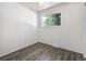 Simple bedroom with wood floors, a window overlooking trees, and a ceiling fan at 7936 Eaton St, Arvada, CO 80003