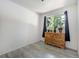 Bright bedroom featuring wood-look floors, natural light, and classic wooden dresser at 7936 Eaton St, Arvada, CO 80003
