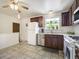 Kitchen with brown cabinets, stainless steel dishwasher, and white refrigerator at 7936 Eaton St, Arvada, CO 80003