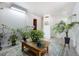 Bright living room with light gray flooring, neutral walls, with several potted plants and a decorative rug at 7936 Eaton St, Arvada, CO 80003
