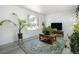 Bright living room with light gray flooring, neutral walls, a large window, and a decorative rug at 7936 Eaton St, Arvada, CO 80003