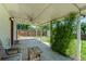 Covered patio overlooking a large, grassy backyard and wooden fence at 7936 Eaton St, Arvada, CO 80003