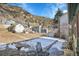 Backyard with a patio area overlooking the surrounding mountain landscape at 1918 Virginia St, Idaho Springs, CO 80452