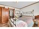 Bedroom with beautiful brass bed, vintage lamps, and open doorway at 1918 Virginia St, Idaho Springs, CO 80452