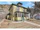 Charming two-story yellow home with red trim and a well-maintained front yard at 1918 Virginia St, Idaho Springs, CO 80452