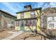 Inviting two-story home featuring a yellow exterior and surrounded by mature trees at 1918 Virginia St, Idaho Springs, CO 80452