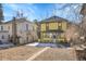 View of yellow house with well-maintained yard and neighborhood setting at 1918 Virginia St, Idaho Springs, CO 80452