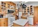 Bright kitchen featuring wood cabinets, an island, and stainless steel appliances at 1918 Virginia St, Idaho Springs, CO 80452