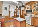 Bright kitchen featuring wood cabinets, an island, and stainless steel appliances at 1918 Virginia St, Idaho Springs, CO 80452