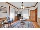 Living room with classic details, hardwood floors, and natural light from lace-curtained windows at 1918 Virginia St, Idaho Springs, CO 80452