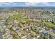 Expansive aerial view of a residential neighborhood, showcasing the community layout, green spaces, and numerous homes at 5207 S Jericho Way, Centennial, CO 80015