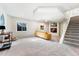 Cozy basement with plush carpeting, staircase and TV niche, perfect for relaxation and entertainment at 5207 S Jericho Way, Centennial, CO 80015