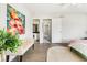 Bright bedroom featuring a cream colored couch and access to a bathroom and hallway at 5207 S Jericho Way, Centennial, CO 80015
