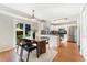 Eat-in kitchen features stainless steel appliances, modern white cabinetry, a dining table, and sliding doors to the backyard at 5207 S Jericho Way, Centennial, CO 80015