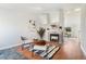 Bright living room with a cozy fireplace, stylish seating arrangement, hardwood floors, and neutral decor at 5207 S Jericho Way, Centennial, CO 80015
