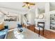 Open-concept living room with a fireplace, hardwood floors, stairs to the second level, and lots of natural light at 5207 S Jericho Way, Centennial, CO 80015
