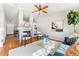 Spacious living room featuring a fireplace, built-in shelving, ceiling fan, and a comfortable blue sofa at 5207 S Jericho Way, Centennial, CO 80015