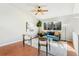 Bright living room with a comfortable blue sofa, large window, ceiling fan, and contemporary decor at 5207 S Jericho Way, Centennial, CO 80015