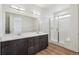Bright bathroom with double vanity, undermount sinks, and glass-enclosed shower at 6384 E 154Th Pl, Thornton, CO 80602