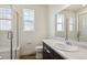 Bright bathroom featuring a glass-enclosed shower, white tile and modern vanity at 6384 E 154Th Pl, Thornton, CO 80602