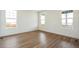 Light and airy bedroom with wood-style floors and bright windows at 6384 E 154Th Pl, Thornton, CO 80602