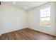 Bright bedroom with a view, wood flooring, and white trim at 6384 E 154Th Pl, Thornton, CO 80602