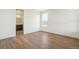 Bright bedroom featuring wood floors, white walls and trim, and a view to the ensuite bathroom at 6384 E 154Th Pl, Thornton, CO 80602