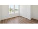 Light bright bedroom with wood-style floors, closet and large windows at 6384 E 154Th Pl, Thornton, CO 80602