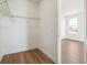 Walk-in closet with metal shelving, white walls, and wood flooring at 6384 E 154Th Pl, Thornton, CO 80602