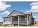 Angle view of the front of the house, showing the porch, windows, and surrounding landscape at 6384 E 154Th Pl, Thornton, CO 80602