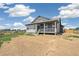 Two-story home showing the covered front porch, backyard, and landscaping at 6384 E 154Th Pl, Thornton, CO 80602