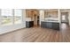 Modern kitchen with wood cabinets, dark gray island, and stainless steel appliances, perfect for culinary enthusiasts at 6384 E 154Th Pl, Thornton, CO 80602