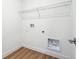 A laundry room with hook ups and wood flooring at 6384 E 154Th Pl, Thornton, CO 80602