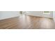 Bright living room with sleek wood floors and sliding glass door offering natural light and access to the deck at 6384 E 154Th Pl, Thornton, CO 80602