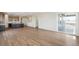 Spacious living room with sleek wood floors and a sliding door to a deck; open-concept design at 6384 E 154Th Pl, Thornton, CO 80602