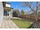 Backyard with artificial grass, pavers, gravel, and a wooden fence at 1622 W 67Th Ave, Denver, CO 80221