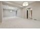 Spacious finished basement featuring neutral carpeting, recessed lighting, and architectural columns at 1622 W 67Th Ave, Denver, CO 80221