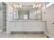 Bathroom featuring a double vanity with ample lighting and a large mirror at 1622 W 67Th Ave, Denver, CO 80221