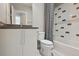 Bathroom featuring modern vanity with unique shower curtain and tiled shower at 1622 W 67Th Ave, Denver, CO 80221