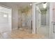 Bathroom boasting a glass-enclosed shower with decorative tiles, and an adjacent walk-in closet at 1622 W 67Th Ave, Denver, CO 80221