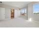 Bright bedroom featuring large windows offering ample natural light and an en-suite bathroom at 1622 W 67Th Ave, Denver, CO 80221