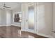 Bright entryway with hardwood floors, a decorative glass door, and a view into a sunlit room at 1622 W 67Th Ave, Denver, CO 80221